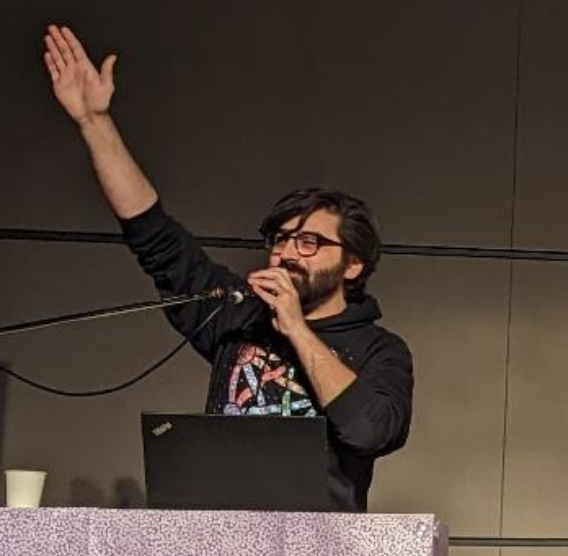 Alex Gleason performing an interesting gesture